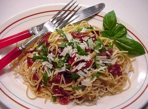 Whole wheat pasta with oven-dried cherry tomatoes, basil ribbons, and grated Pecorino Romano cheese. Divine!